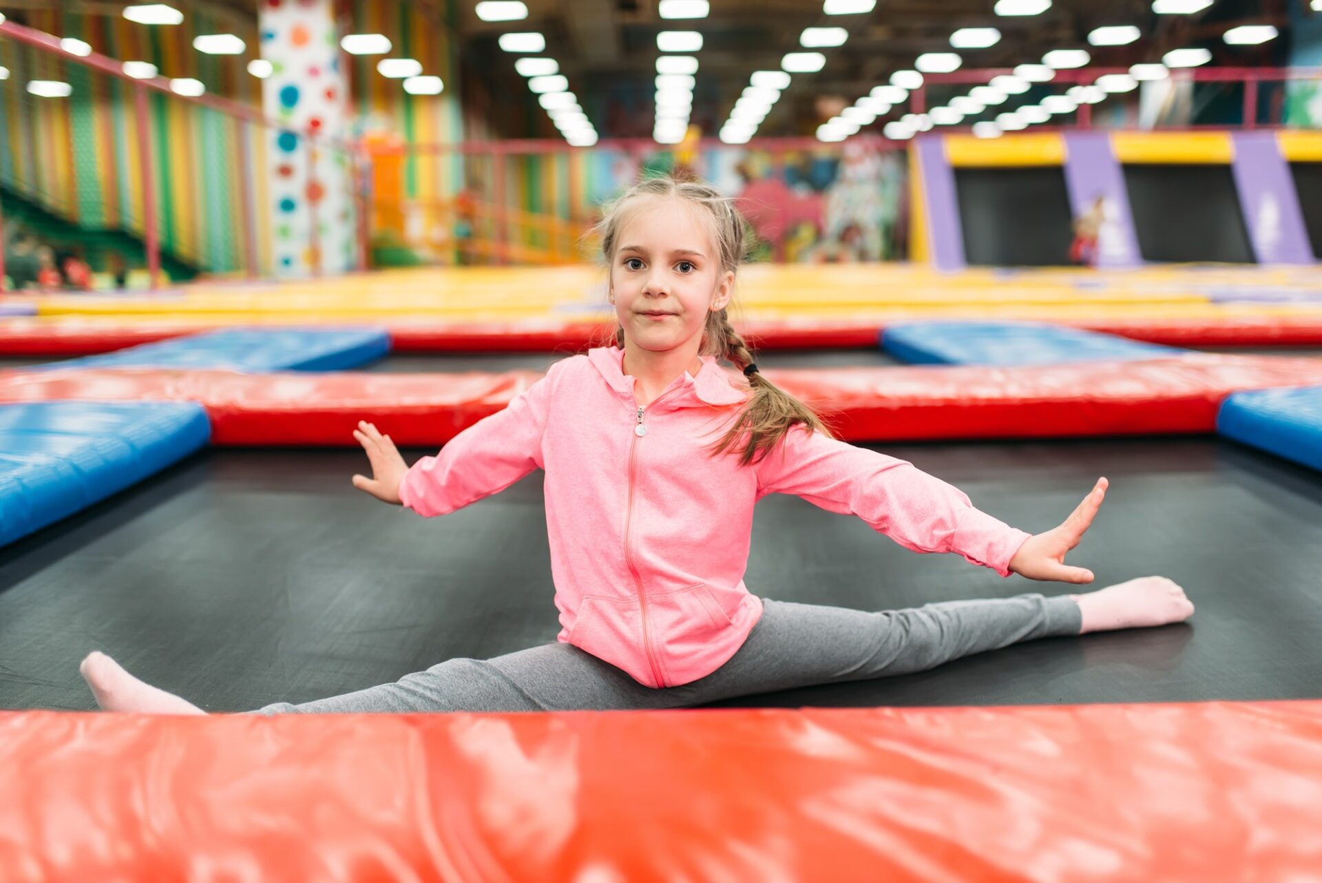 Flexible girl on playground, entertainment center